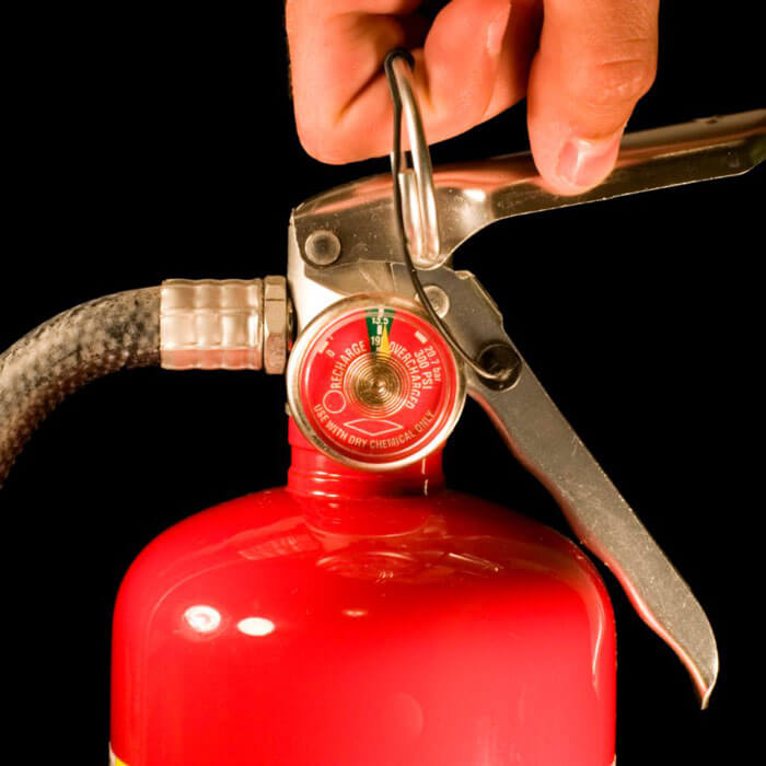Red carbon dioxide fire extinguisher with metal handle and hose shown in Phoenix, AZ